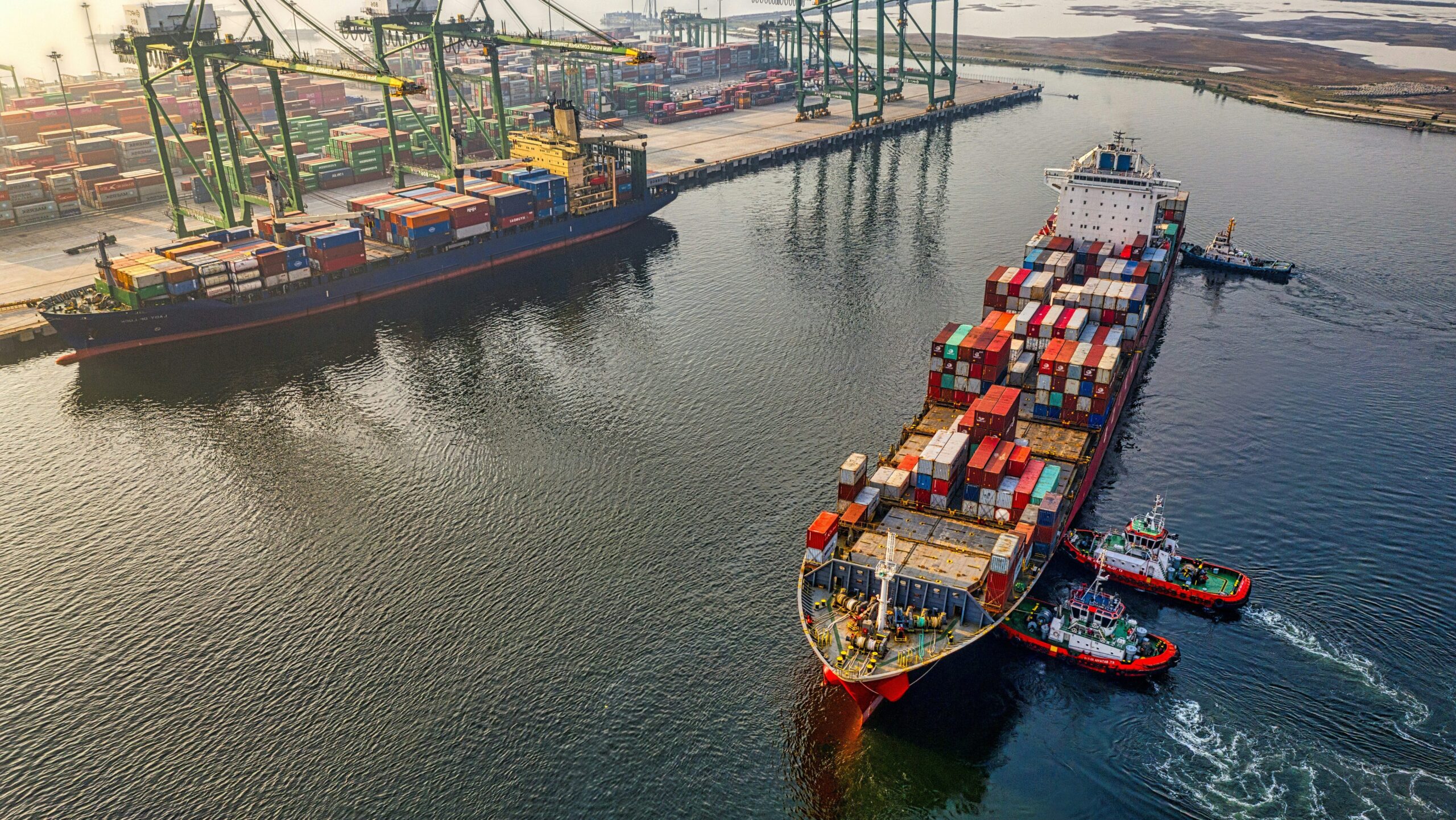 Photograph of cargo ships leaving port.